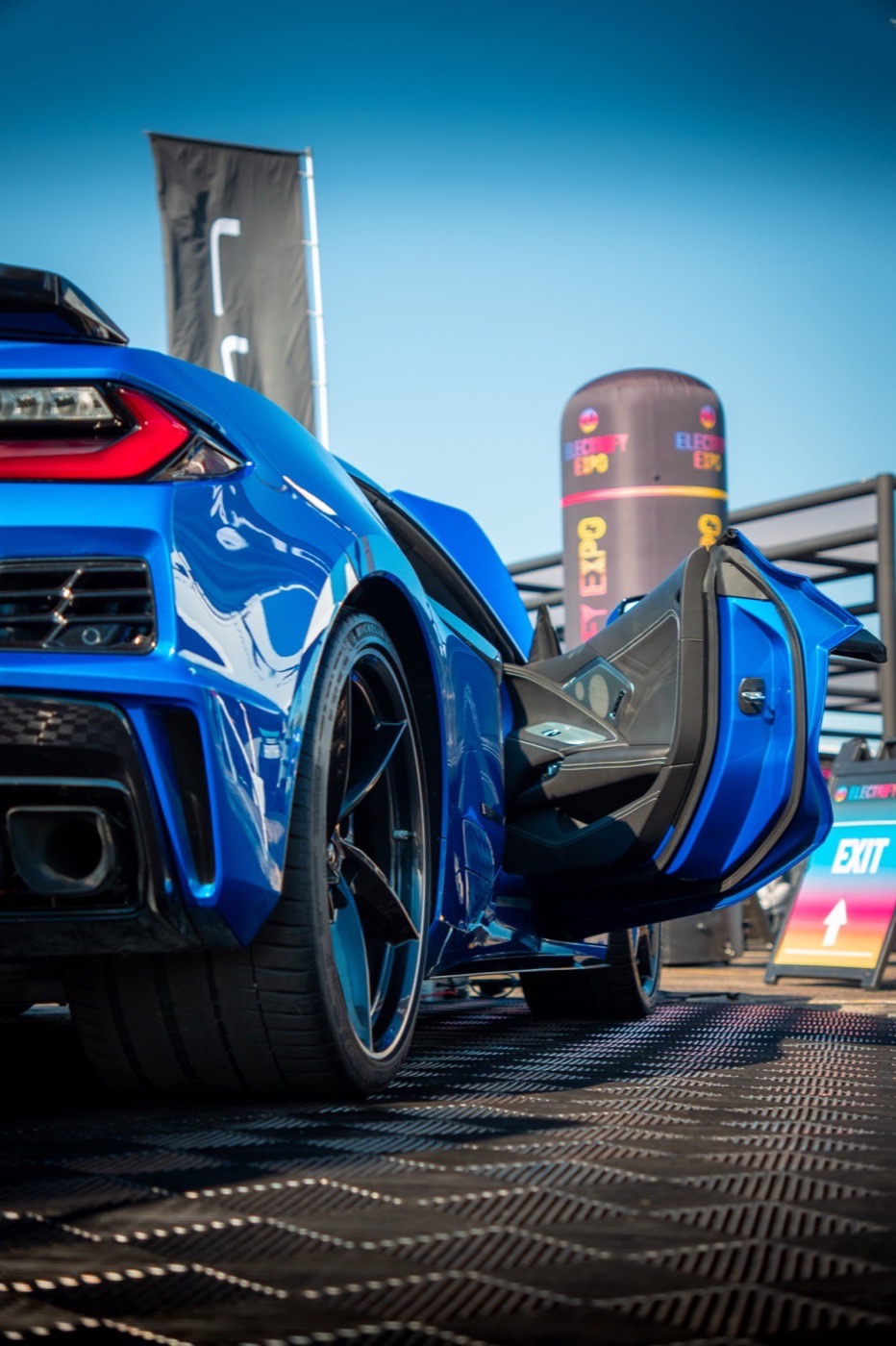 Blue Corvette photographed from a low angle at an expo