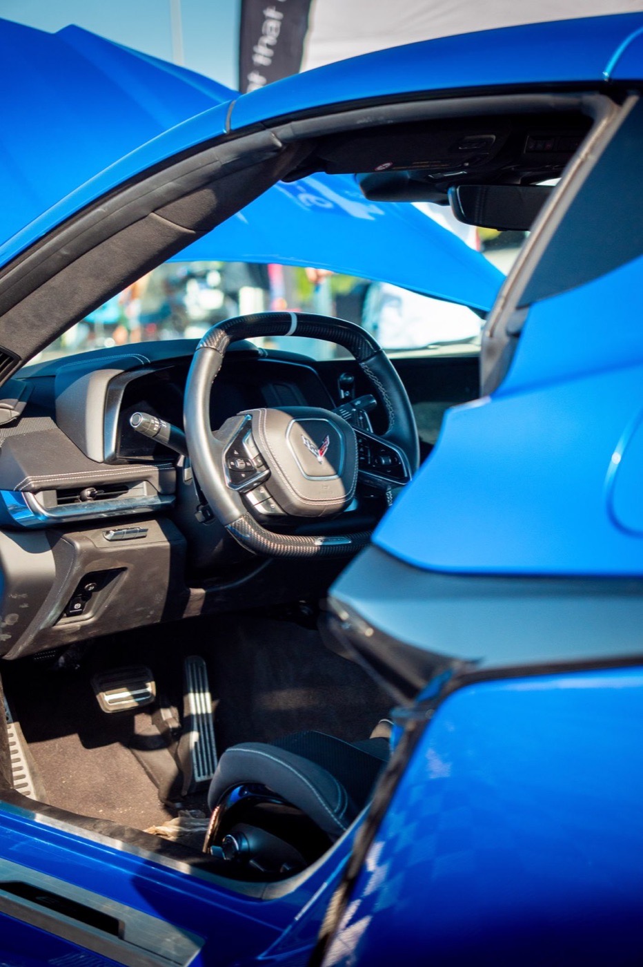 View into the blue interior of a sports car through the open door
