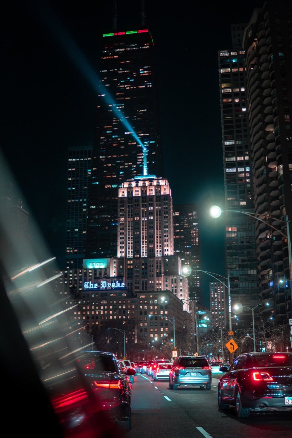 Chicago skyline at night with a bright beam of light rising into the sky