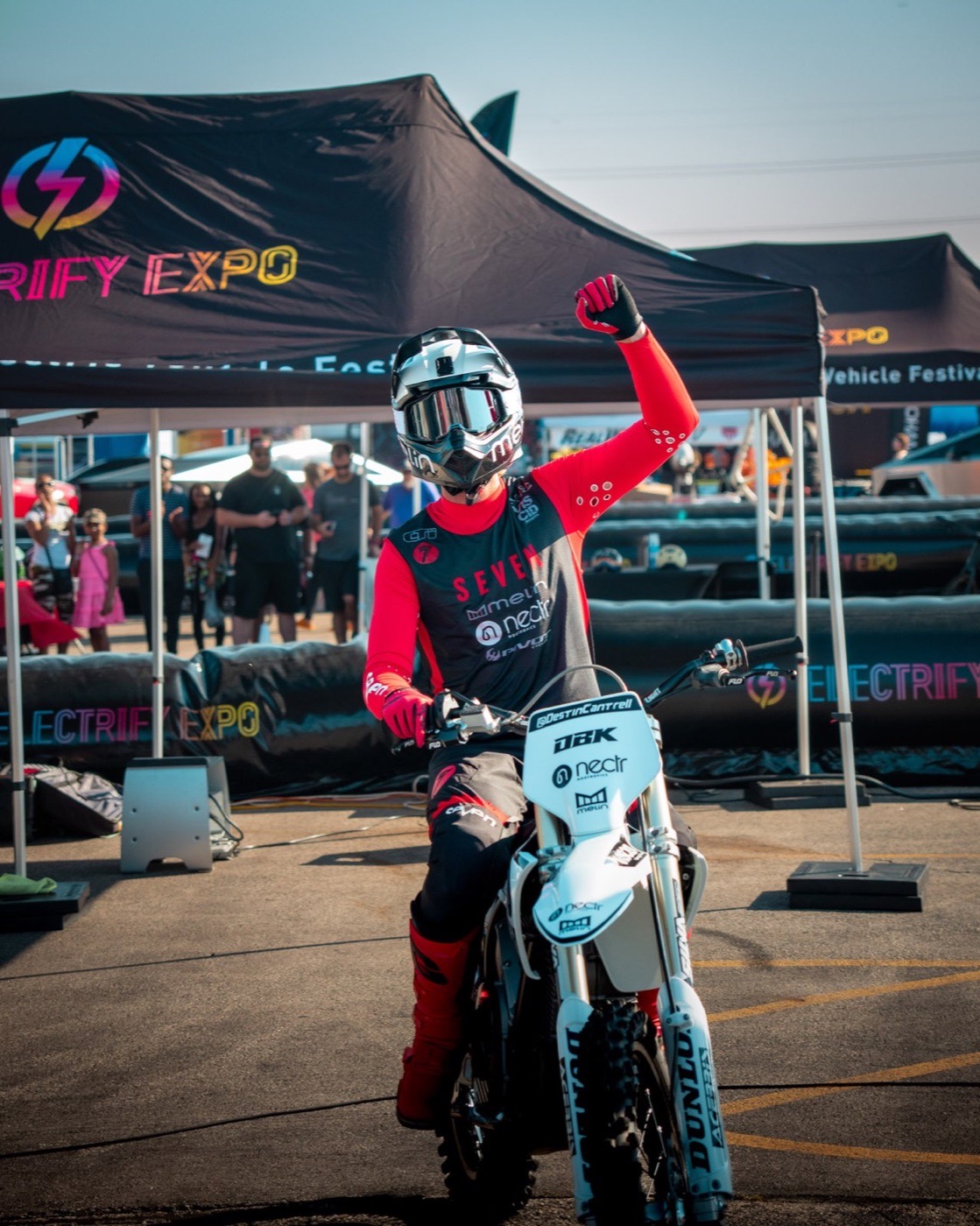 Motorbike rider posing at an outdoor expo event