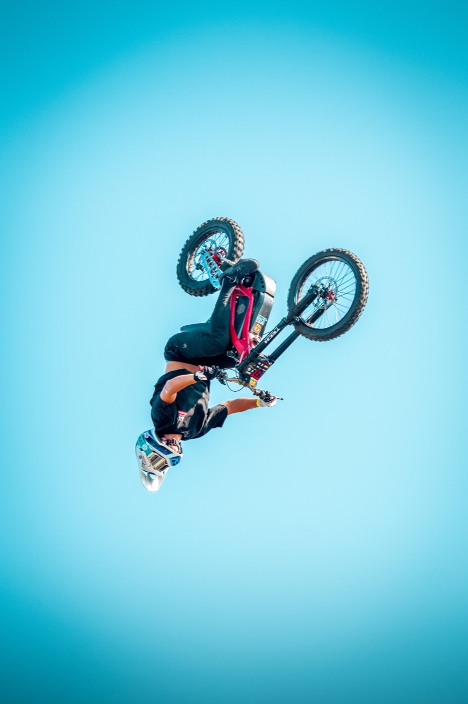 Motocross rider upside down in the sky during a jump