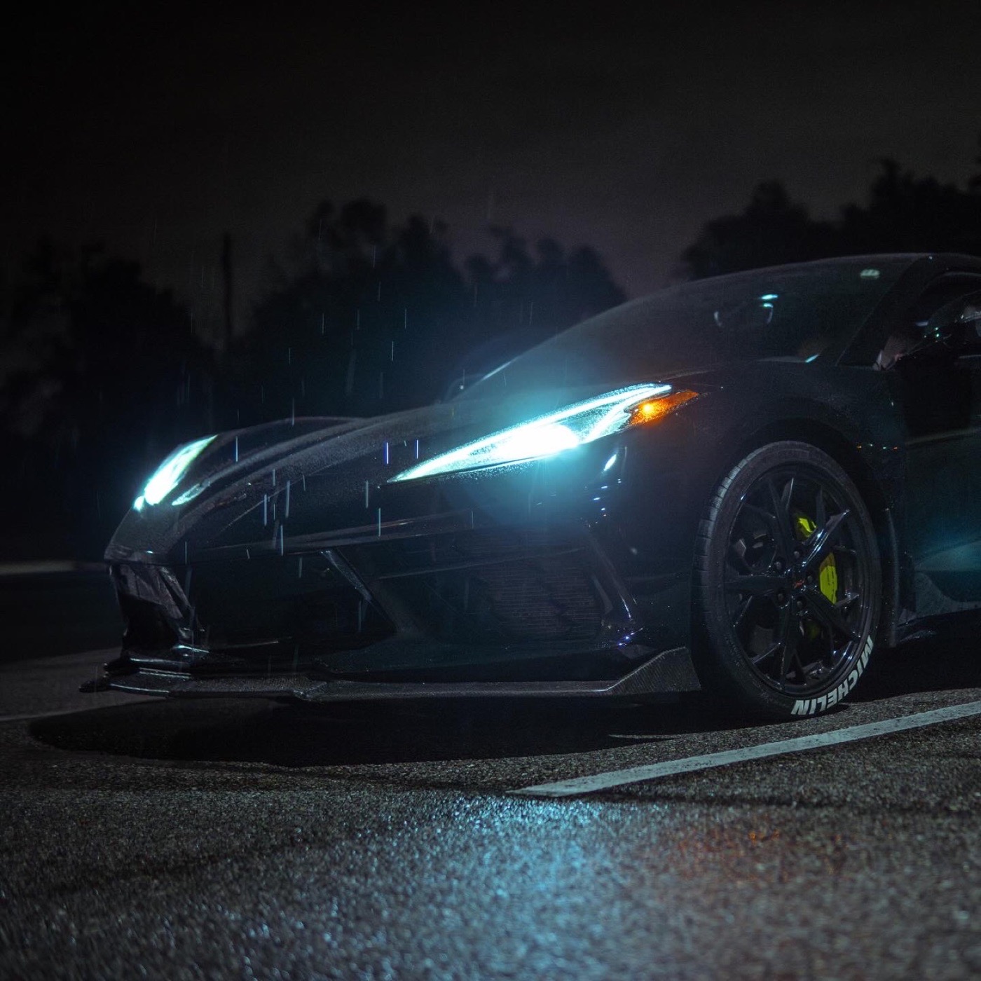 Night automotive photograph of a Corvette in the rain