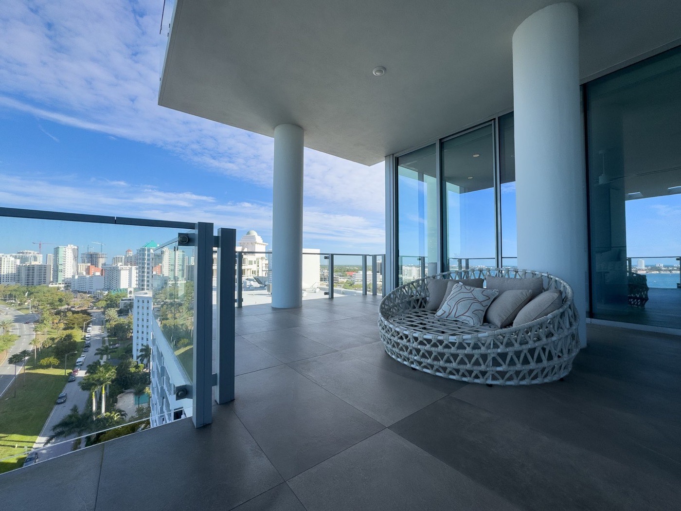 Modern balcony overlooking the city and water in bright daylight