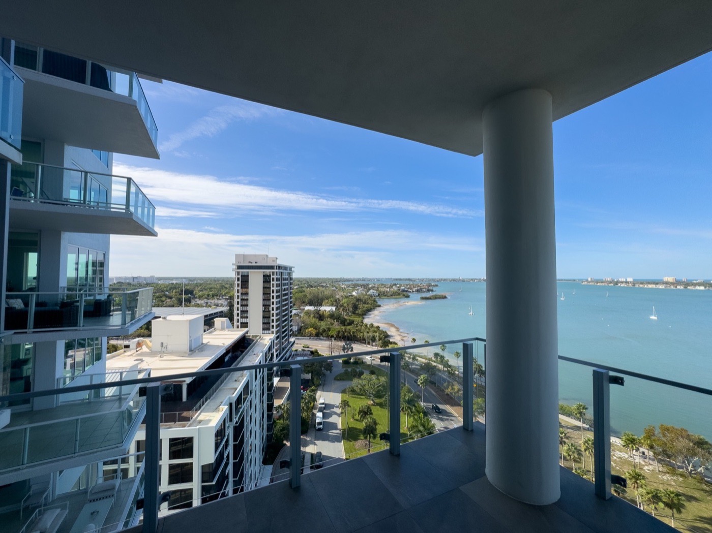 High-rise balcony overlooking water and city buildings