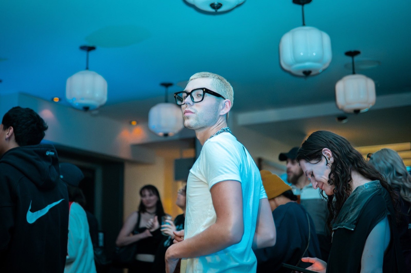 Candid party portrait with a sharply focused subject in a crowded room