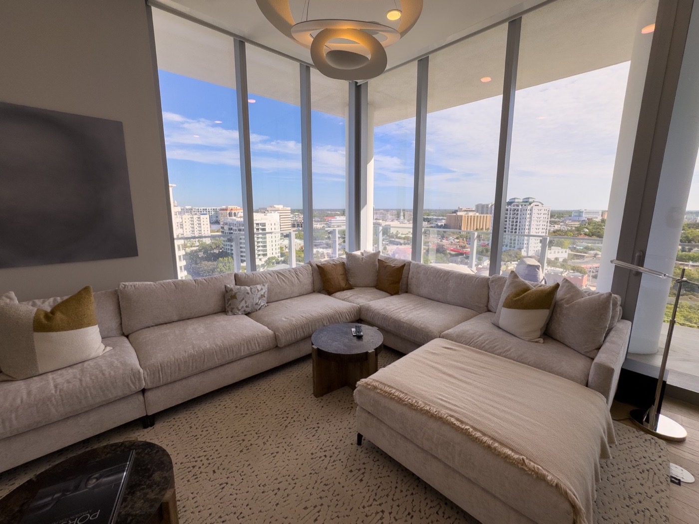Luxury living room with wide city views through tall windows