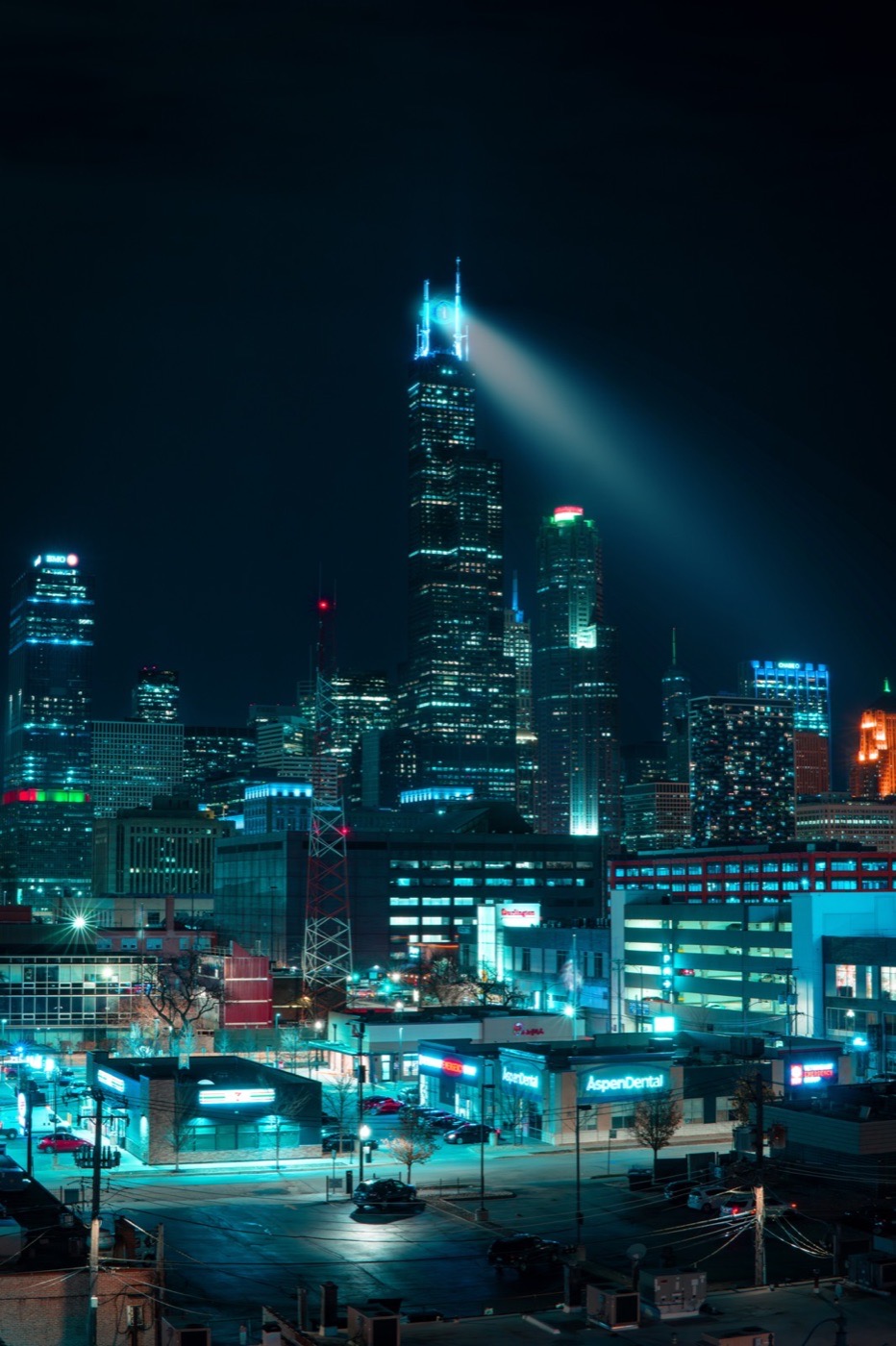 Night skyline with bright beam of light from a skyscraper